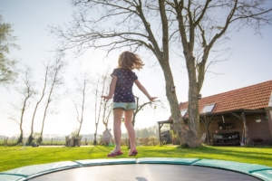 Little girl bouncing on a trampoline