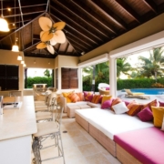 outdoor kitchen with overhang and ceiling fans in tropical setting