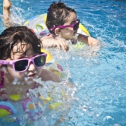girls swimming in pool splash fun