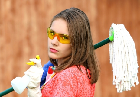 girl holding cleaning products clean